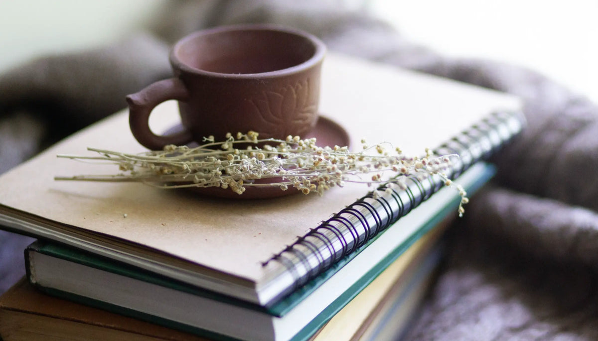 A stack of books with earthy tones and a coffee cup — mushroom books documentaries resources