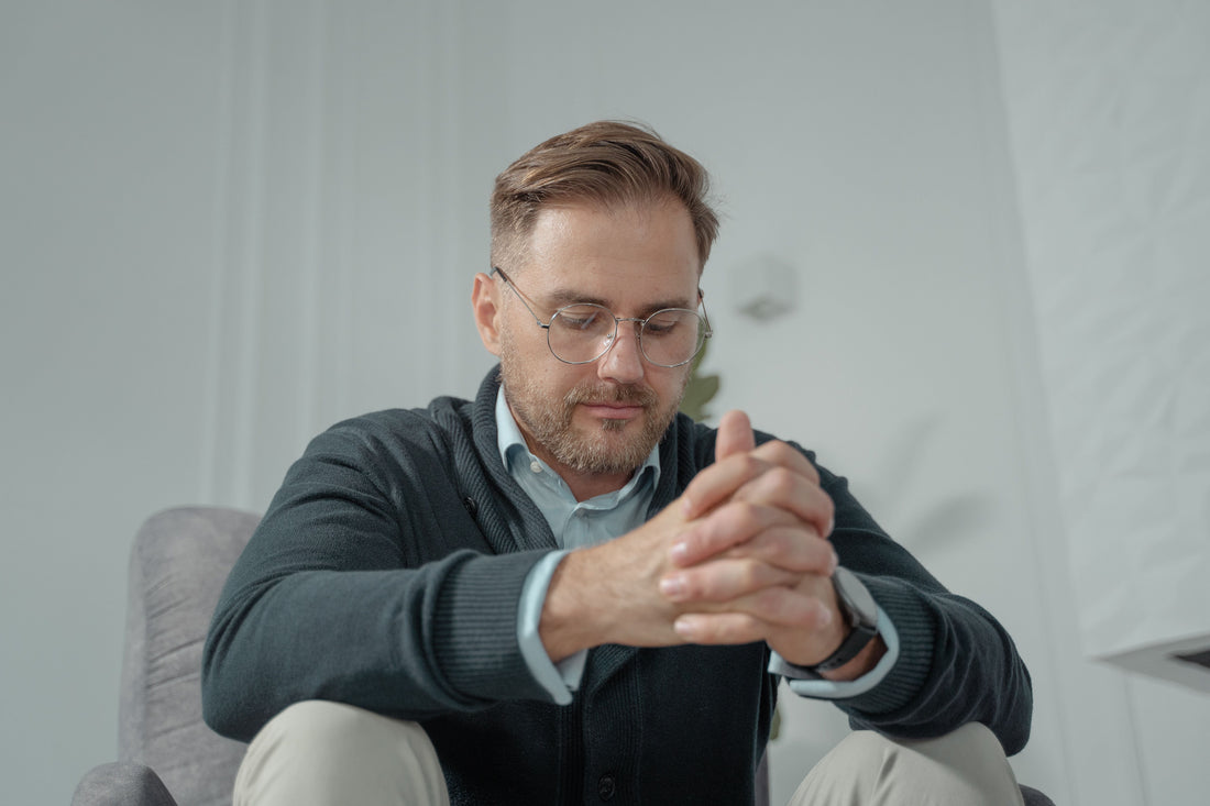  A person sitting thoughtfully indoors, calm expression — working with difficult emotions in microdosing
