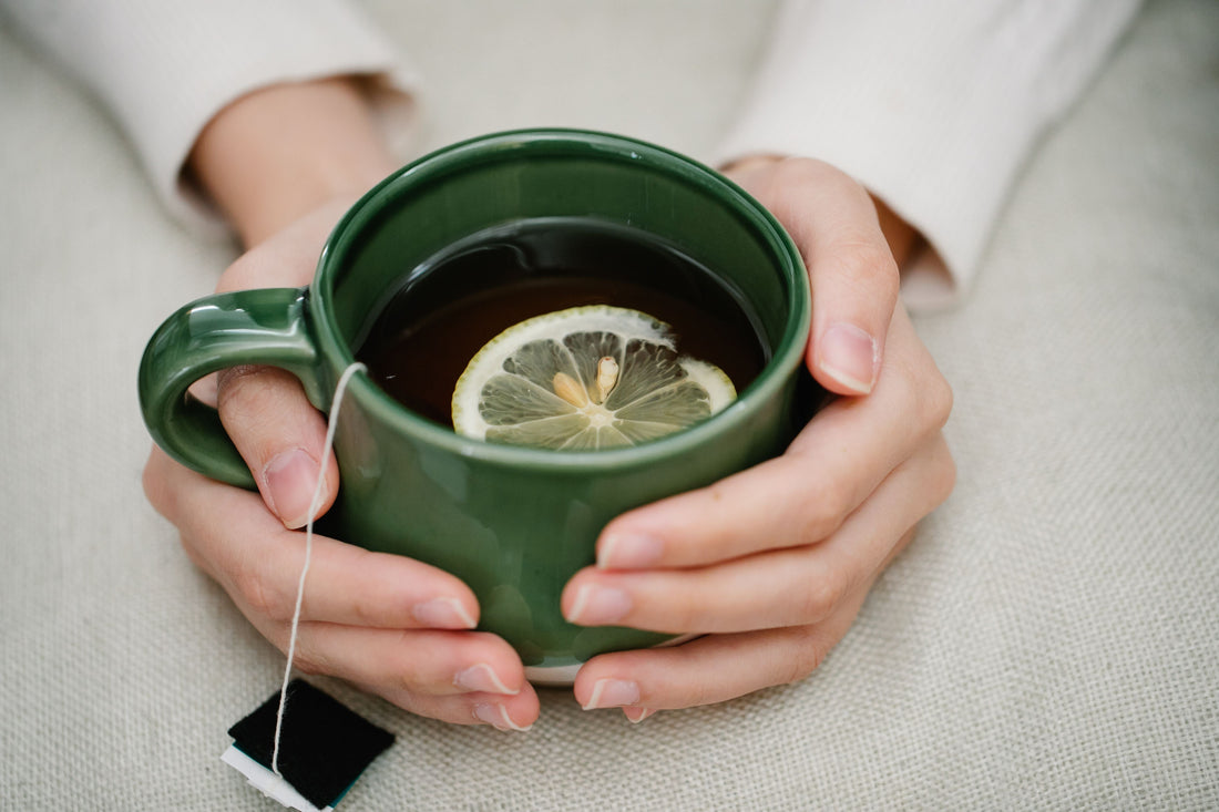 Hands cradling a warm mug in soft morning light, representing a daily microdosing ritual in a Medicine Box blog