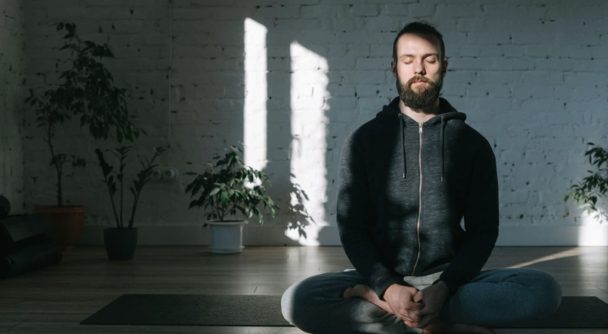 A person with eyes closed, calm breath, hands resting in lap — microdosing and intrusive thoughts guide